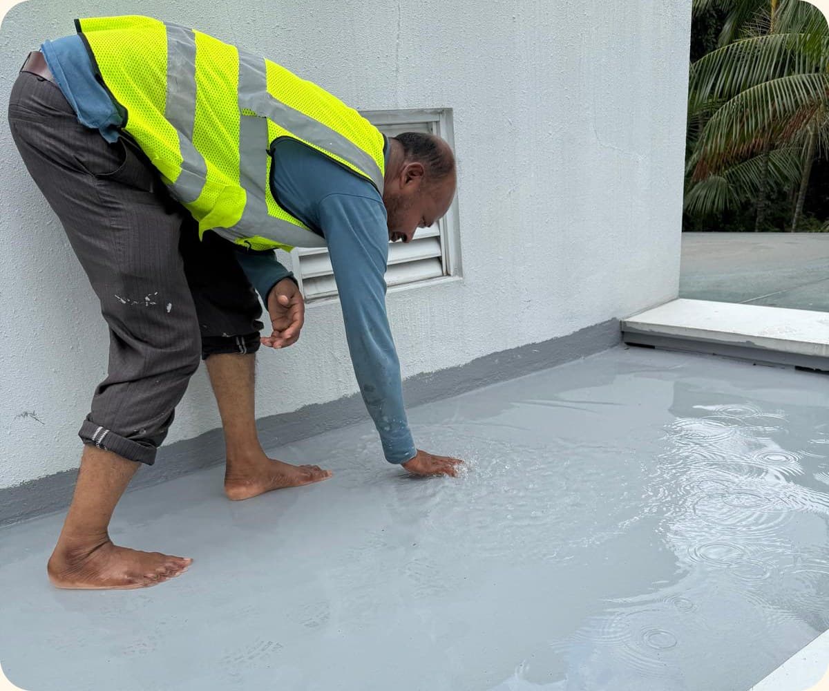Technician spreading membrane over a balcony floor