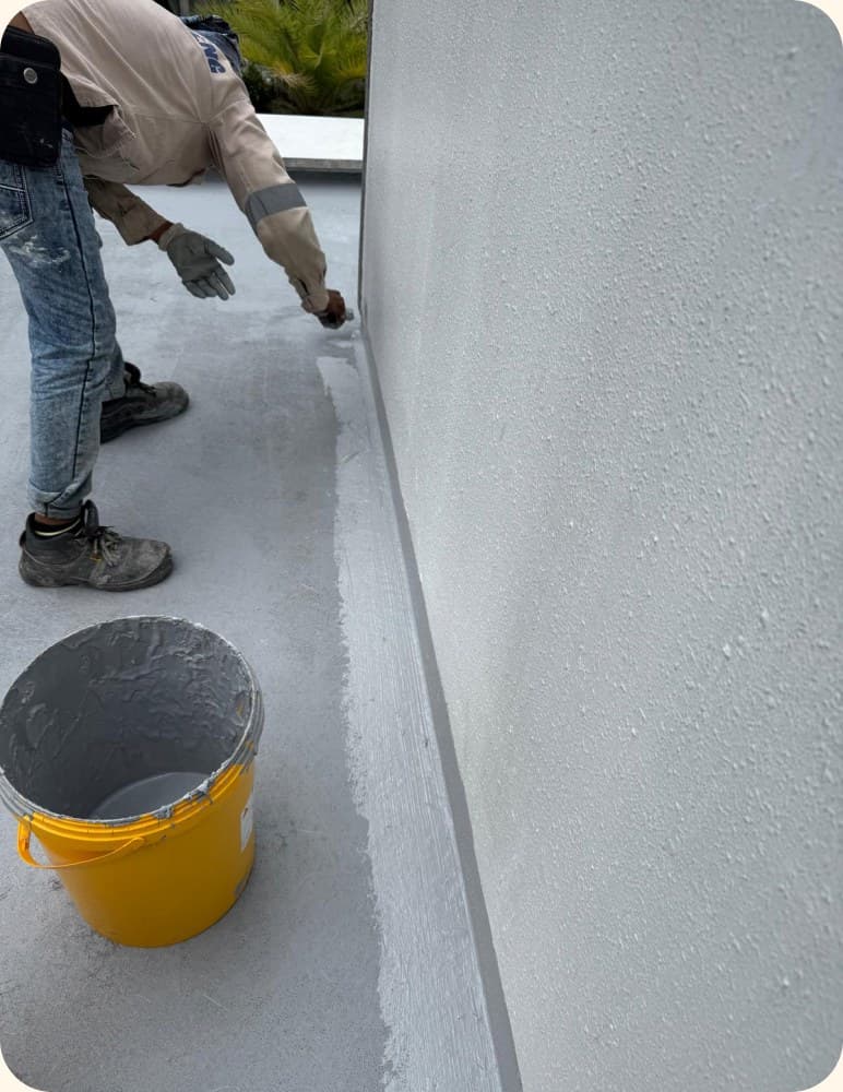 Coating a parapet wall with waterproof paint