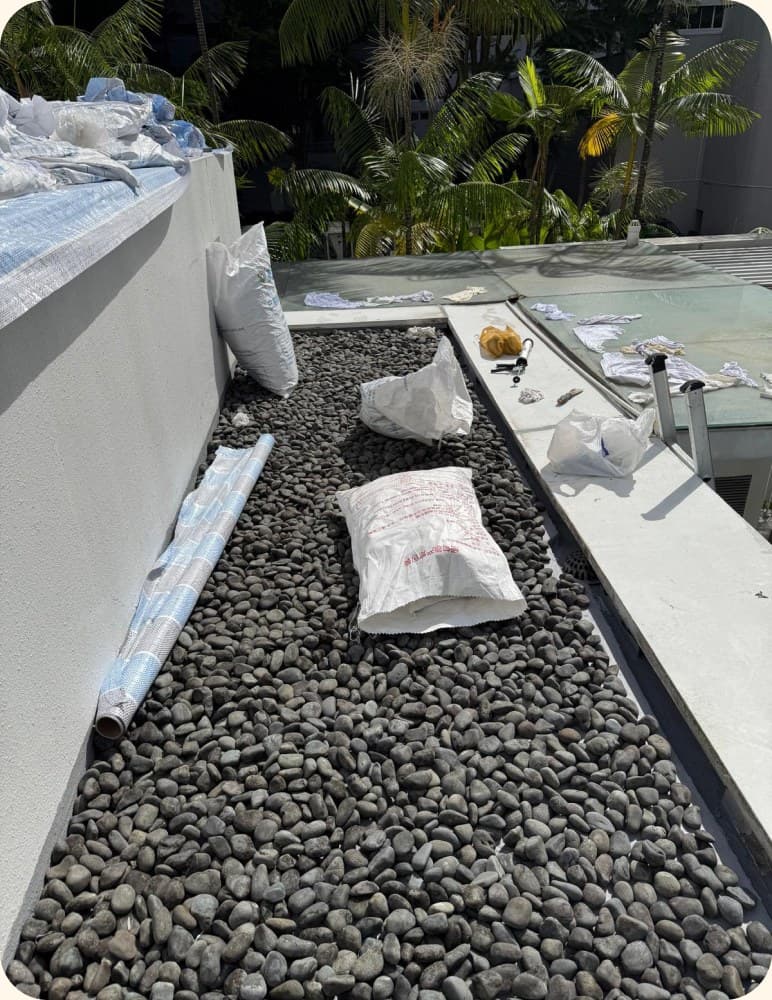 Gravel drainage bed laid along a roof channel