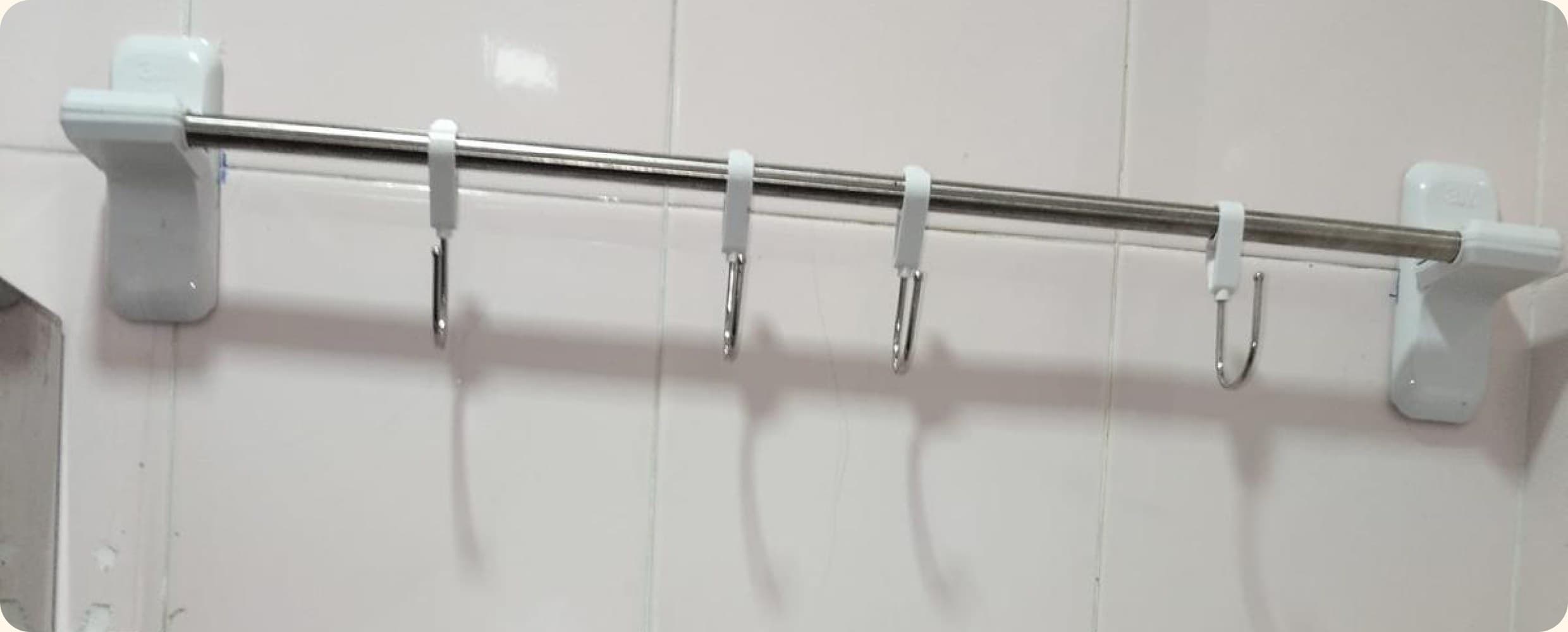 Towel rail and hooks mounted on a tiled wall